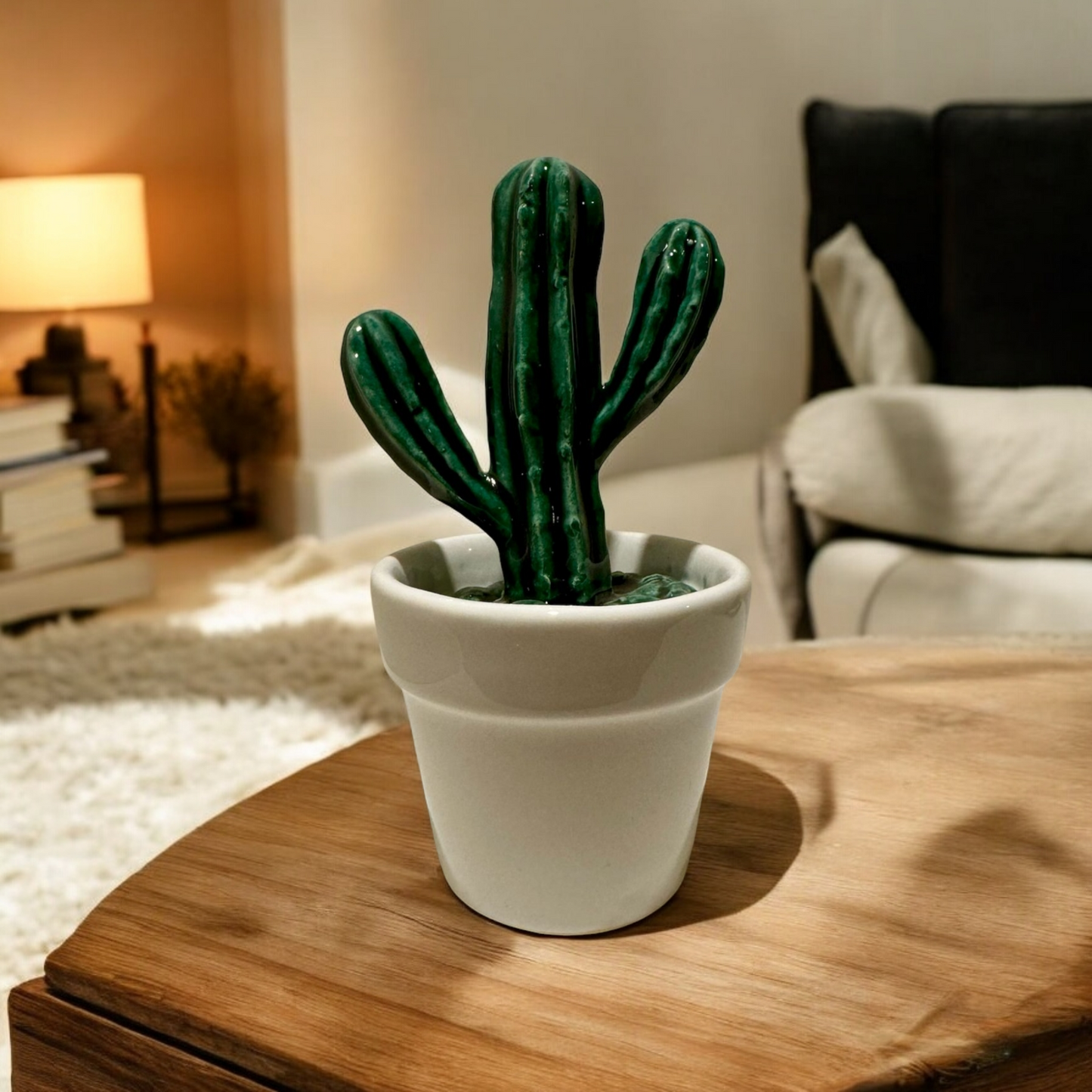 Ceramic cactus decoration on a wooden table and bright living room in the background