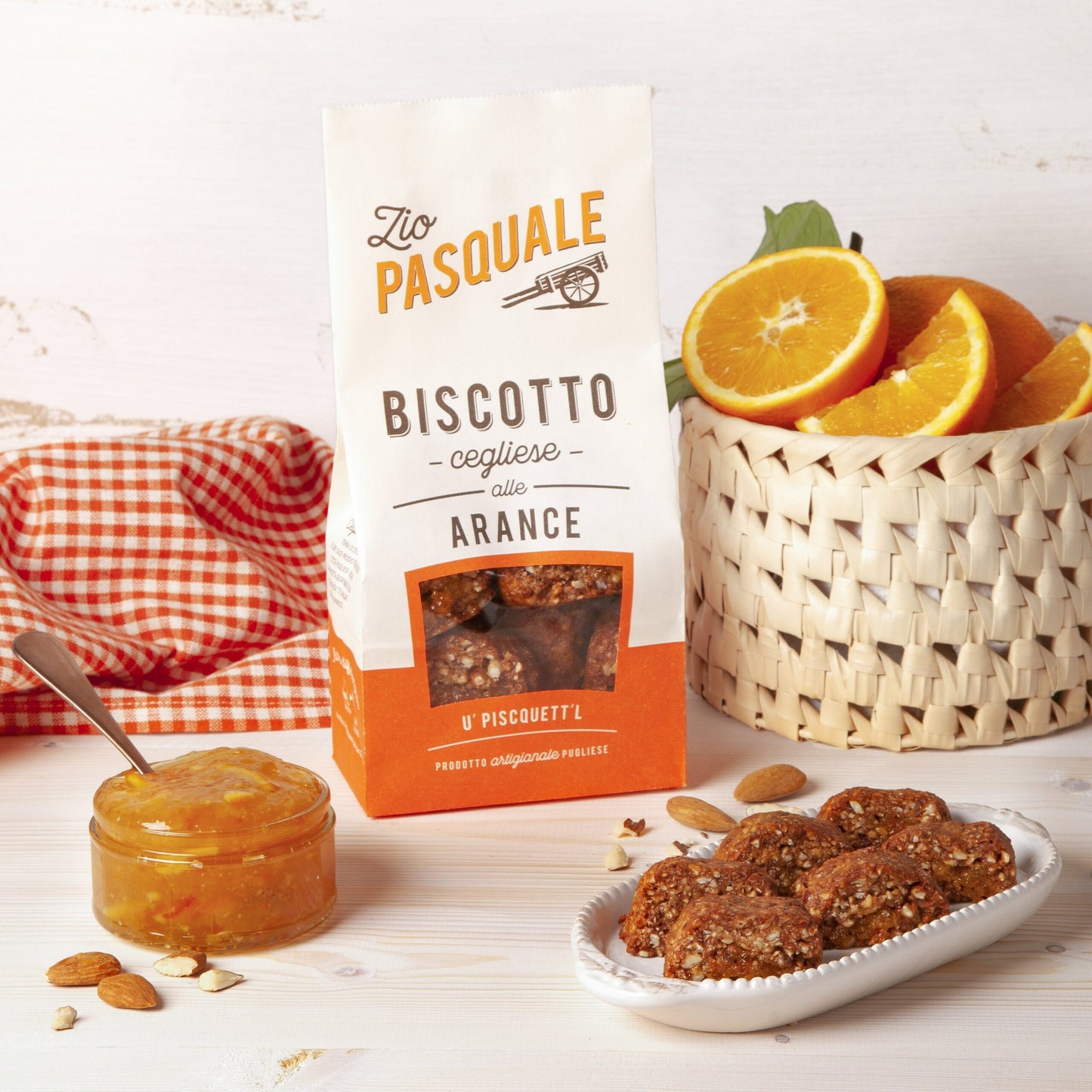 packet of biscuits with fresh ranges and orange marmalade in the background 